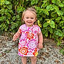 toddler, child, smile, outdoor, greenery, dress, floral_pattern, sandals, necklace, happy, nature, gravel, summer, cute, portrait, person, standing, playful, sunlight, hair