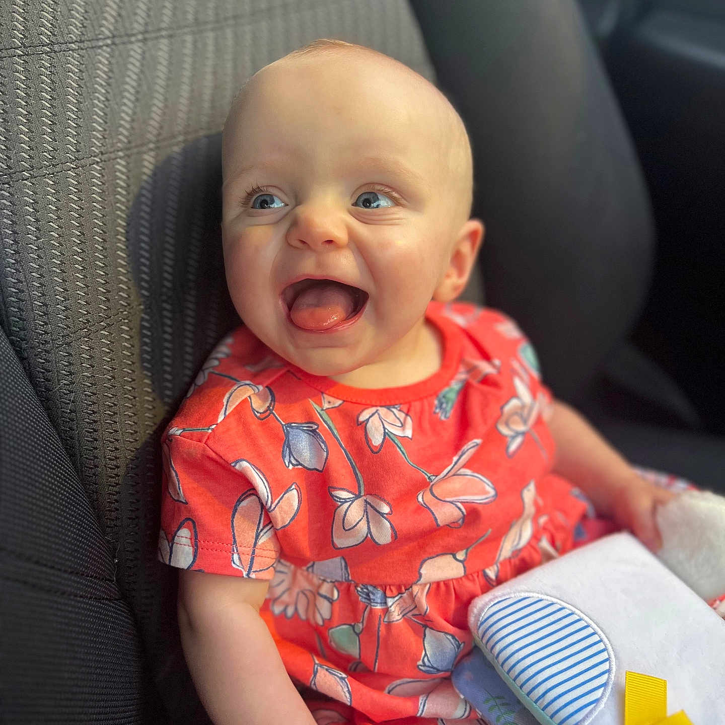 Izabella is registered to the contest to win money with this photo: baby, babylaughing, car, clothing, couch, cushion, dress, face, furniture, happy, head, homedecor, laughing, person, photography, portrait, sitting, t_shirt, transportation, vehicle