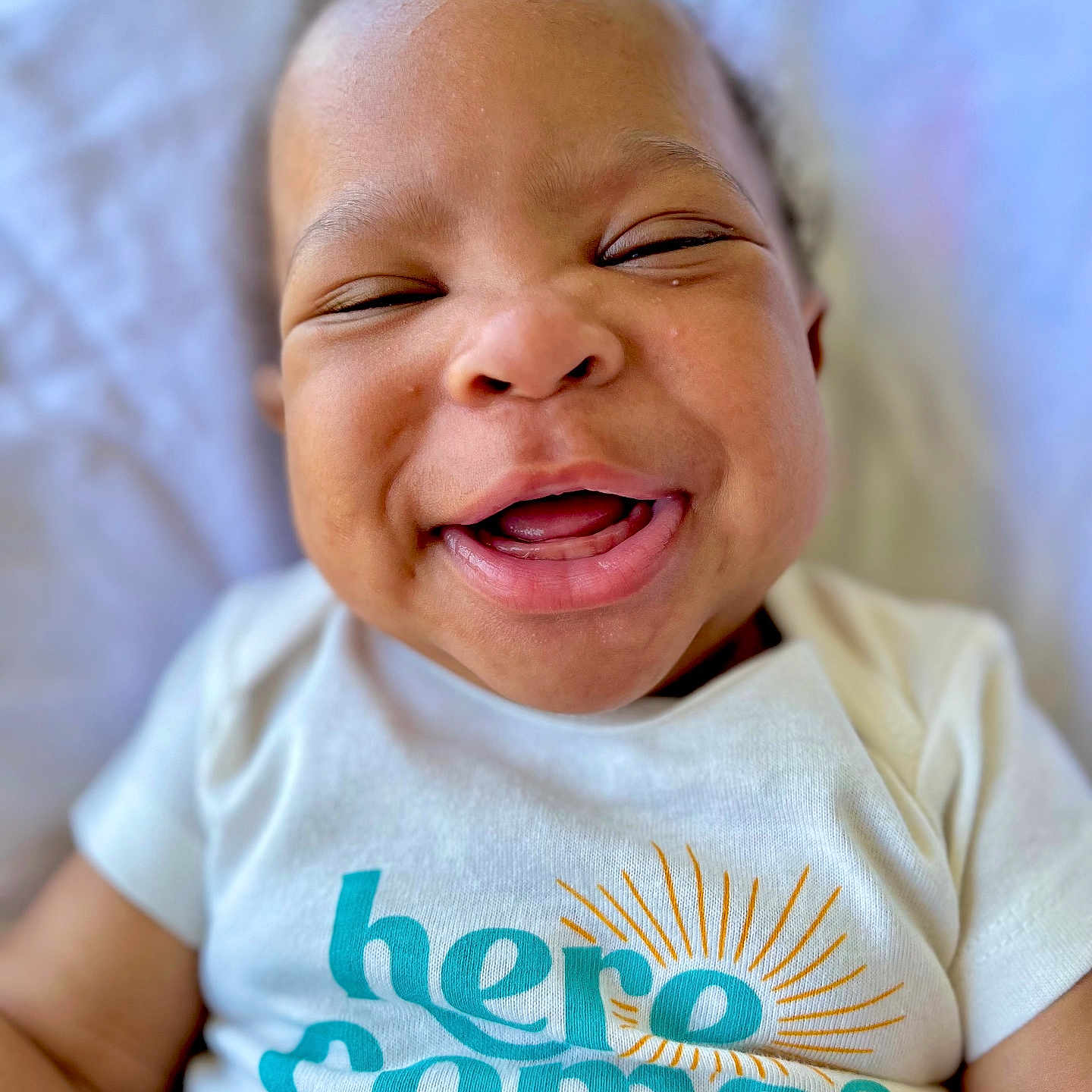 Hezekiah joined the competition — help win amazing prizes! baby, babylaughing, clothing, face, happy, head, laughing, newborn, person, photography, portrait, smile, t_shirt