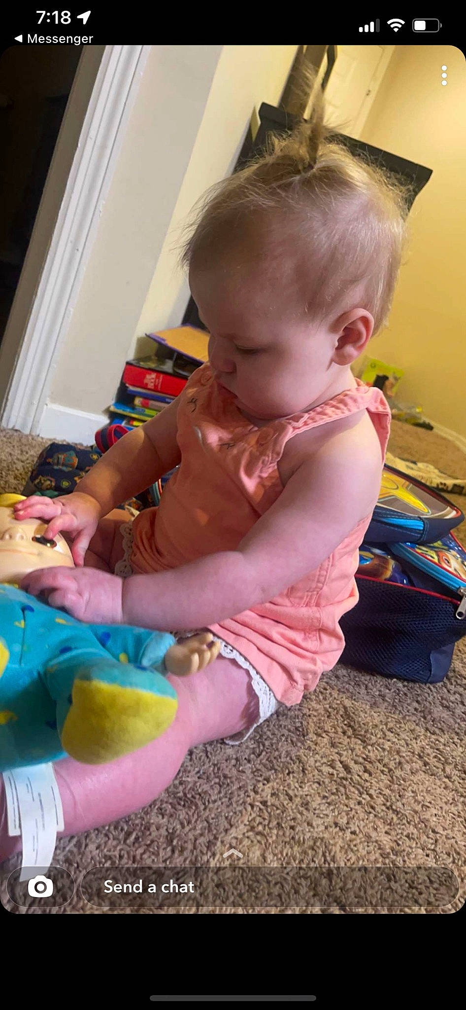 Temperance is registered to the contest to win money with this photo: arm, baby, baby_products, baby_toddler_clothing, child, finger, flooring, fun, nail, person, pink, play, product, sitting, skin, sock, t_shirt, toddler, toy