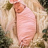 newborn, baby, sleeping, pink, blanket, headwear, flower, soft_texture, cozy, portrait, infant, wrapped, cute, peaceful, monogram, decoration, laying, child, warm, resting