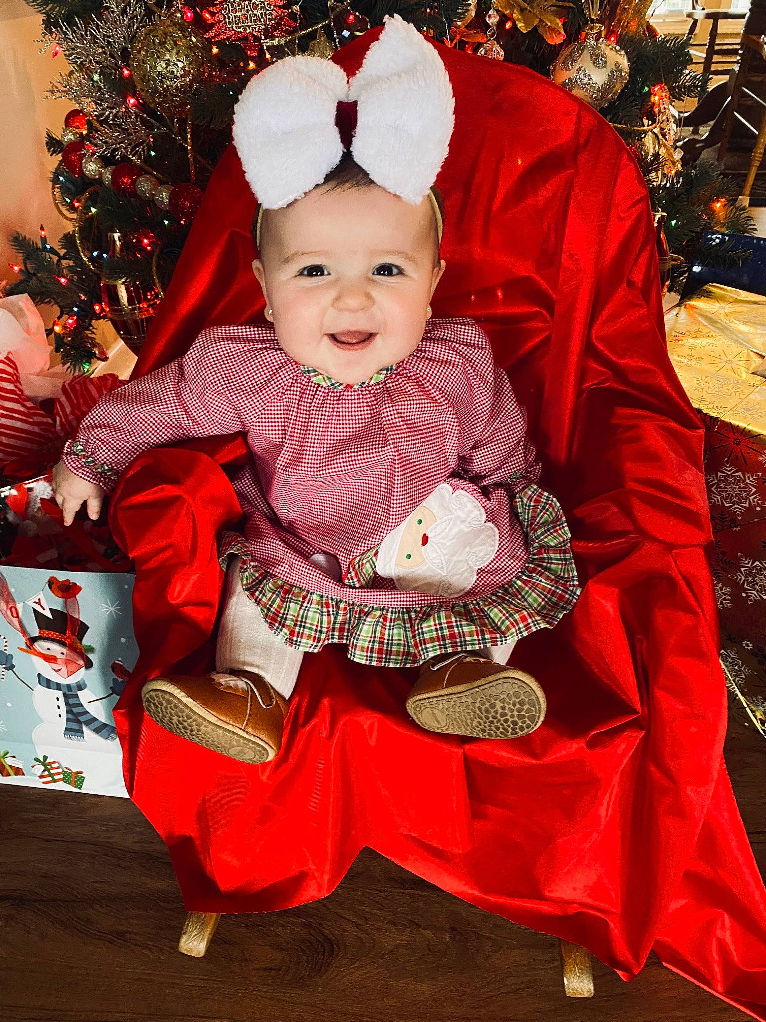 Briar is registered to the contest to win money with this photo: baby, baby_toddler_clothing, christmas, christmas_decoration, christmas_ornament, christmas_tree, costume_hat, event, fun, happy, hat, holiday, human_body, joy, lap, person, pink, red, santa_claus, sleeve