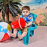 toddler, child, plastic_chair, red_bucket, beach_ball, hawaiian_shirt, shorts, indoor, fake_palm_tree, beach_backdrop, serious_expression, barefoot, colorful_clothing, toy, summer_theme, portrait, playful, studio_photo, young_child, seated