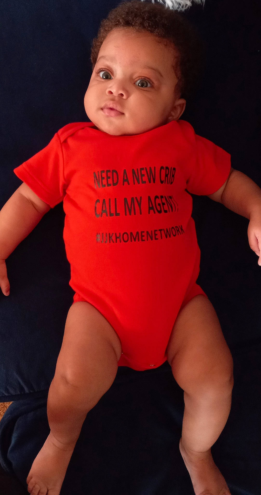 Lawrence is registered to the contest to win money with this photo: baby_toddler_clothing, cheek, face, finger, human, human_body, jersey, joint, knee, leg, lip, mouth, muscle, neck, orange, organ, person, shoulder, sleeve, standing