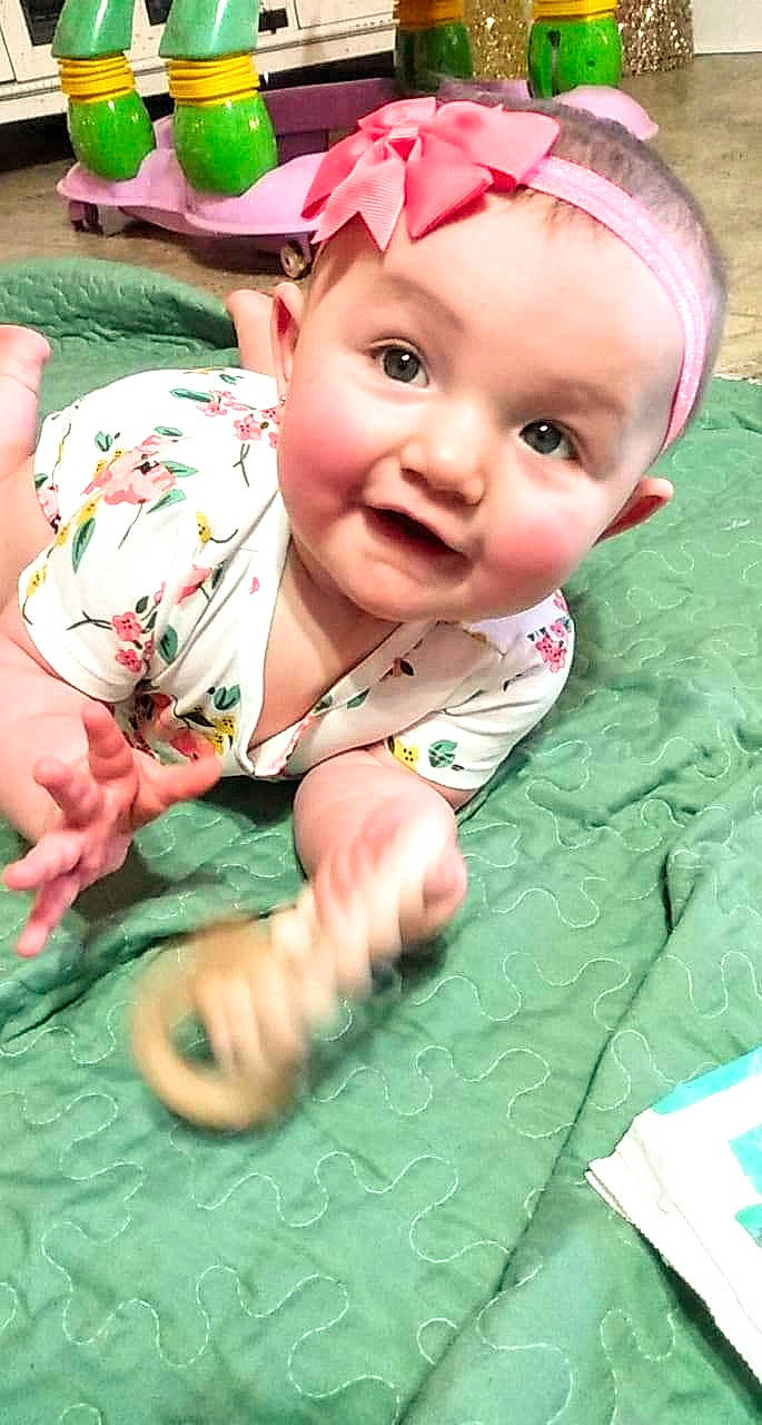 Carleigh is registered to the contest to win money with this photo: baby, baby_laughing, baby_products, baby_toddler_clothing, bonnet, cheek, child, costume_accessory, eye, face, hair_accessory, happy, headband, headpiece, headwear, mouth, nose, person, pink, skin