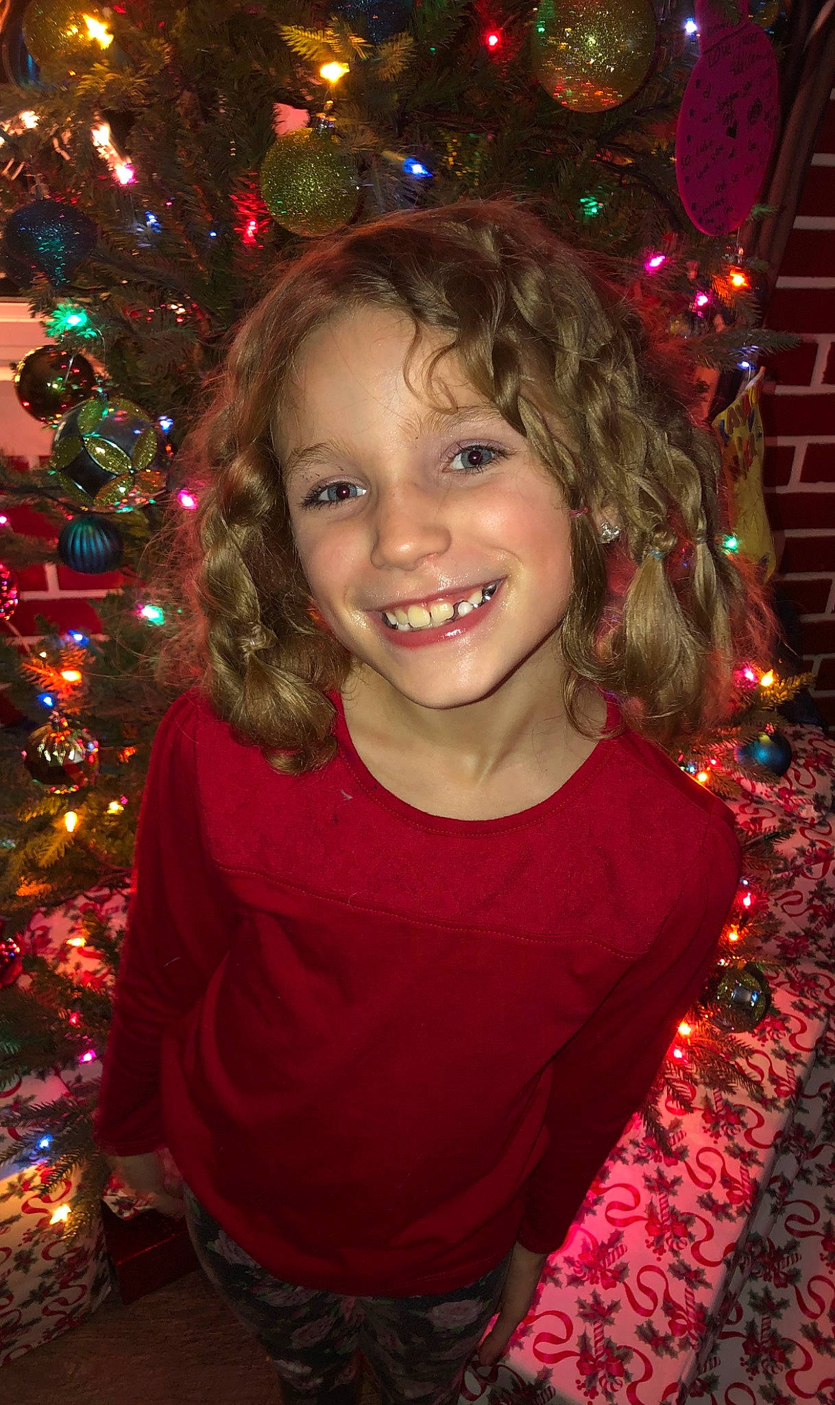 Coralyne is registered to the contest to win money with this photo: child, christmas, christmas_decoration, christmas_eve, christmas_lights, christmas_ornament, christmas_tree, event, face, facial_expression, fir, fun, hair, hairstyle, happy, head, holiday, joy, person, smile