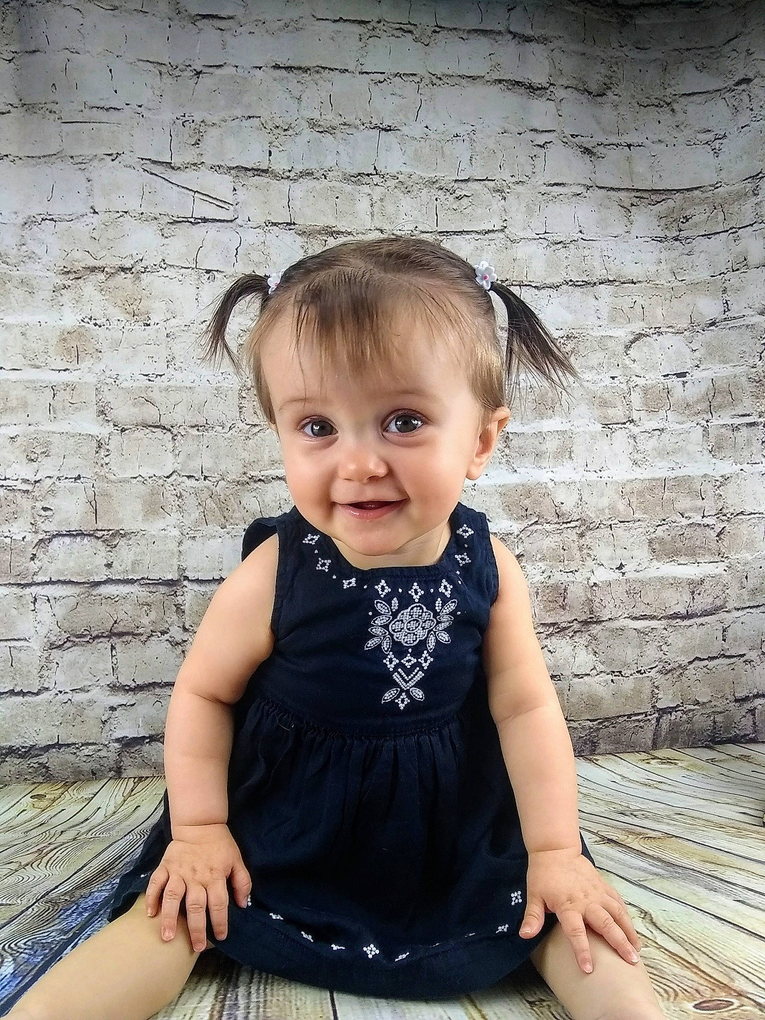 Hayley is registered to the contest to win money with this photo: baby, baby_toddler_clothing, cheek, child, child_model, dress, ear, face, fashion_accessory, head, joy, pattern, person, photo_shoot, photography, sitting, skin, toddler