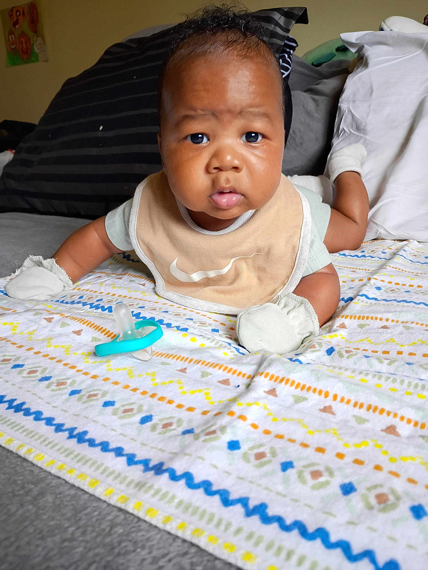 Zi'Cani joined the competition — help win amazing prizes! baby, infant, blanket, pacifier, bed, pillow, mittens, bib, face, expression, indoor, child, cute, lying_down, patterned_blanket, clothing, skin, head, eyes, mouth