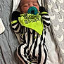 Jameon joined the competition — help win amazing prizes! baby, newborn, infant, sleeping, pacifier, bib, beetlejuice, striped_onesie, black_and_white_stripes, green_accent, blanket, bedding, cozy, indoors, portrait, closeup, cute, hands_up, peaceful, fabric_pattern