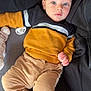 baby, infant, child, blue_eyes, sweater, pants, couch, pacifier, soft_toy, blanket, indoor, portrait, cute, cozy, clothing, person, relaxed, lying_down, childhood, casual