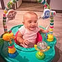 Deja joined the competition — help win amazing prizes! baby, child, activity_center, toy, giraffe_toy, monkey_toy, bird_toy, smiling, indoor, floor, carpet, play, happy, infant, person, colorful, plastic, seat, cute, young