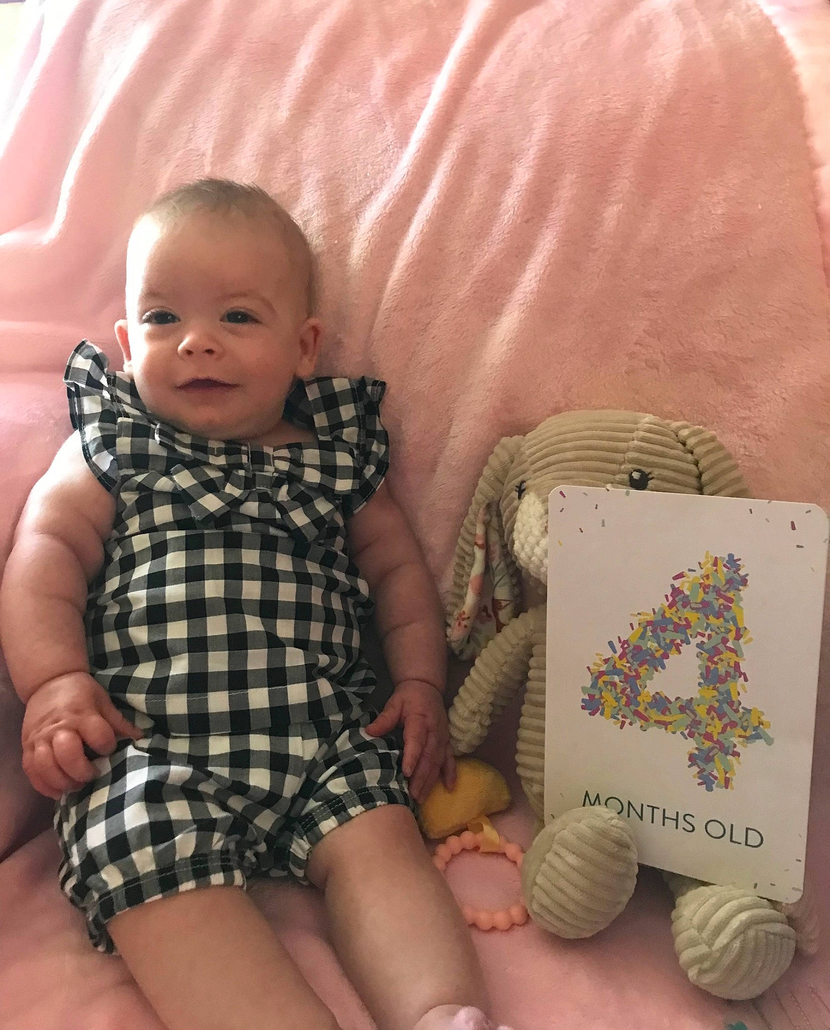 Claire is registered to the contest to win money with this photo: baby, baby_toddler_clothing, child, comfort, finger, happy, human_leg, pattern, person, plaid, pollinator, product, sitting, skin, smile, tartan, textile, thigh, thumb, toddler