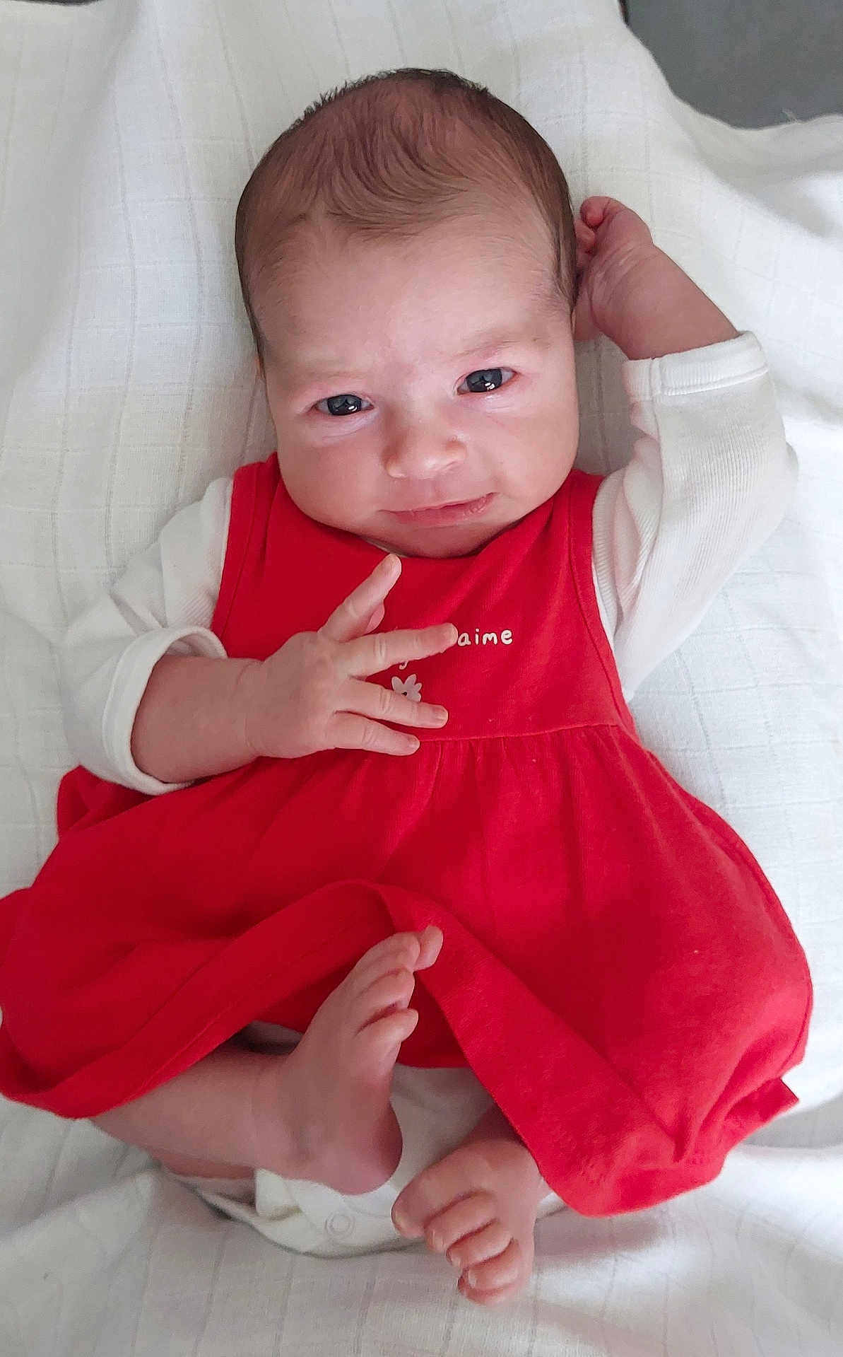 Victoria participe au concours pour gagner de l'argent avec cette photo : baby, infant, red_dress, white_sleeves, blanket, foot, hand, face, eyes, skin, newborn, lying_down, cute, child, portrait, indoors, expression, relaxed, young, person