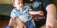 Zane And Rayden joined the competition — help win amazing prizes! adult, child, toddler, glasses, toy, couch, birthday_badge, clothing, shorts, tshirt, wooden_floor, indoor, person, seated, holding, happy, home, casual, skin, hand