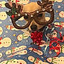dog, reindeer_glasses, christmas_bow, wrapping_paper, snowman_pattern, holiday, festive, cute, pet, costume, decorations, red, blue, ribbons, small_dog, face, eyes, nose, animal, celebration