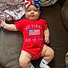 Zylah joined the competition — help win amazing prizes! baby, infant, child, red_onesie, american_flag, bow, headband, socks, white_socks, couch, blanket, indoor, cute, portrait, smiling, celebration, holiday, 4th_of_july, laying_down, person