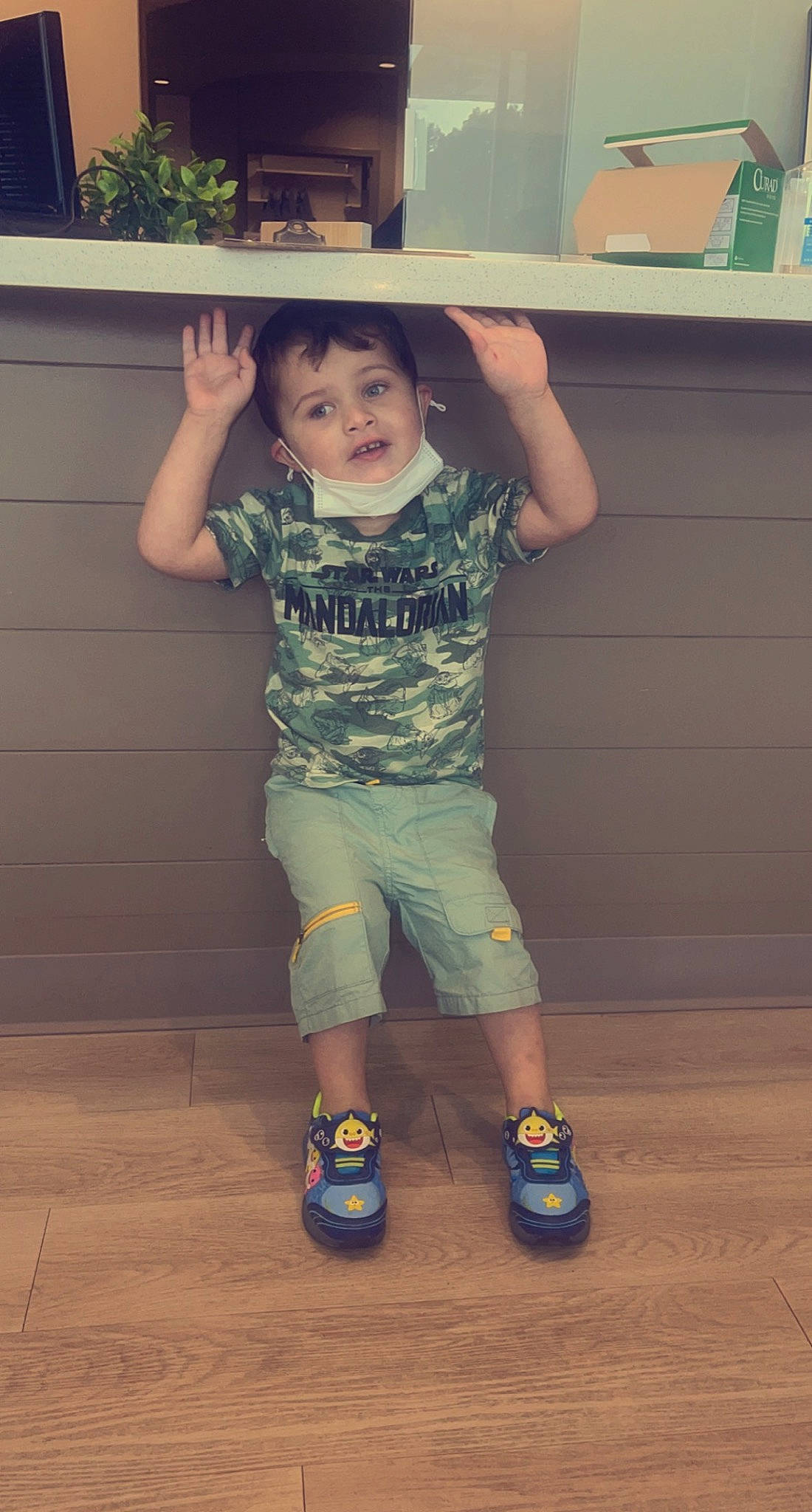 Easton is registered to the contest to win money with this photo: arm, baby_toddler_clothing, cool, floor, flooring, gesture, hand, happy, head, human_body, joint, nose, person, skin, sleeve, smile, standing, t_shirt, thigh, toddler