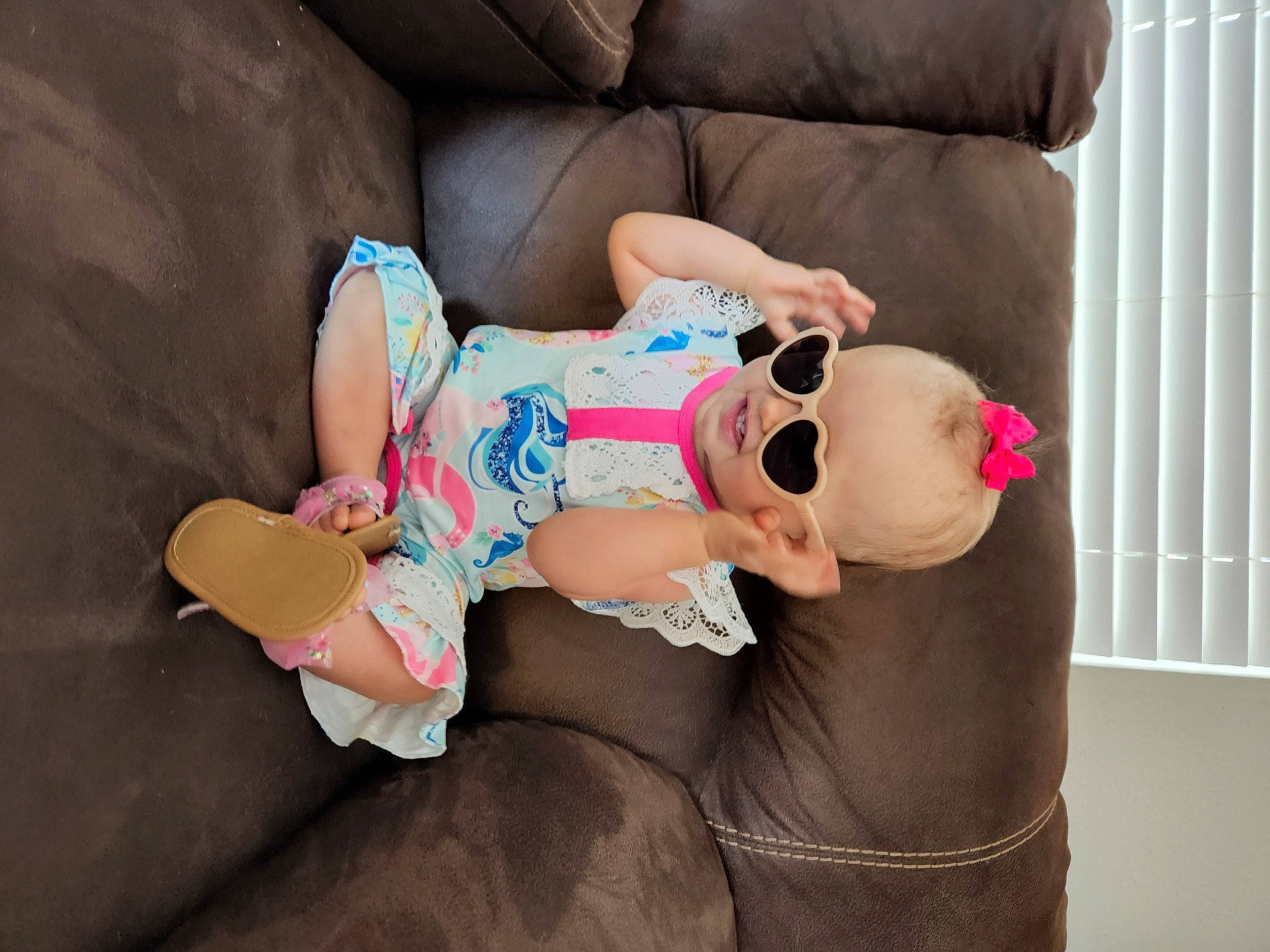 Londynn is registered to the contest to win money with this photo: baby, baby_products, baby_toddler_clothing, comfort, eyewear, finger, glasses, goggles, hat, human_body, human_leg, joint, knee, leg, person, pink, skin, sunglasses, thigh, toddler