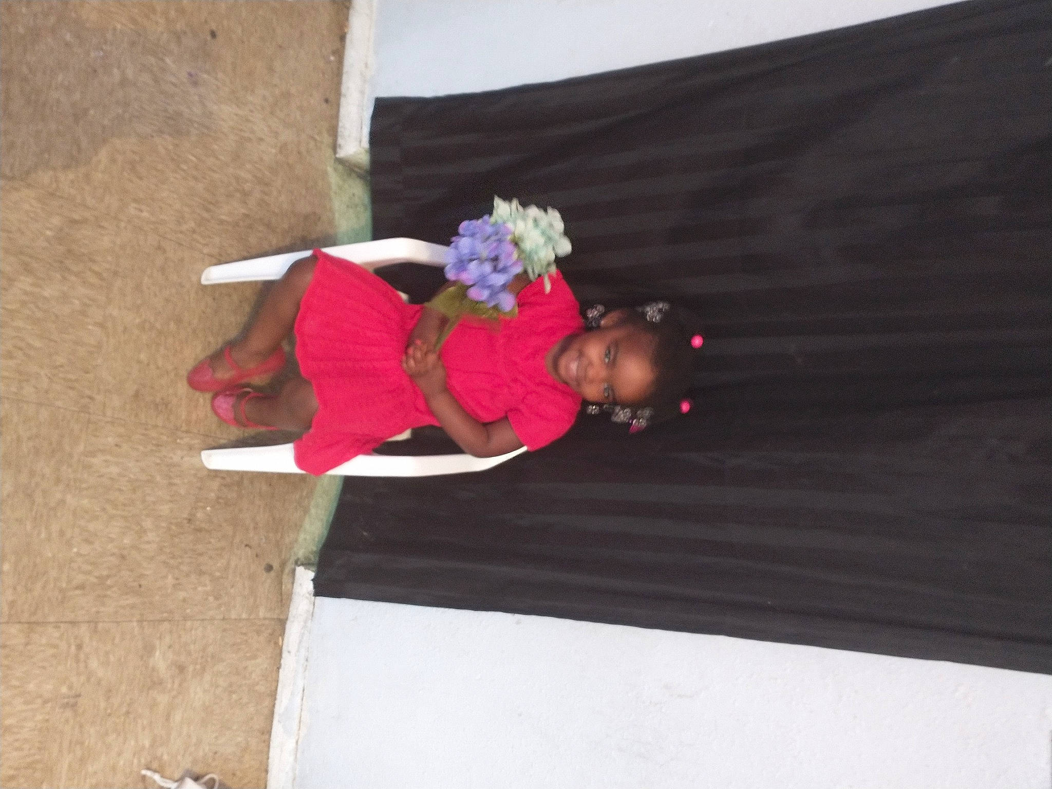 Alaina is registered to the contest to win money with this photo: carmine, child, concrete, costume, event, flooring, fun, hardwood, joy, leisure, magenta, person, recreation, sitting, toddler, tradition, tree, wood