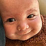 Rex is registered to the contest to win money with this photo: baby, infant, close_up, face, smile, eyes, eyelashes, cheek, nose, skin, brown_jacket, zipper, fuzzy_texture, portrait, candid, adorable, newborn, cozy, indoor, cute
