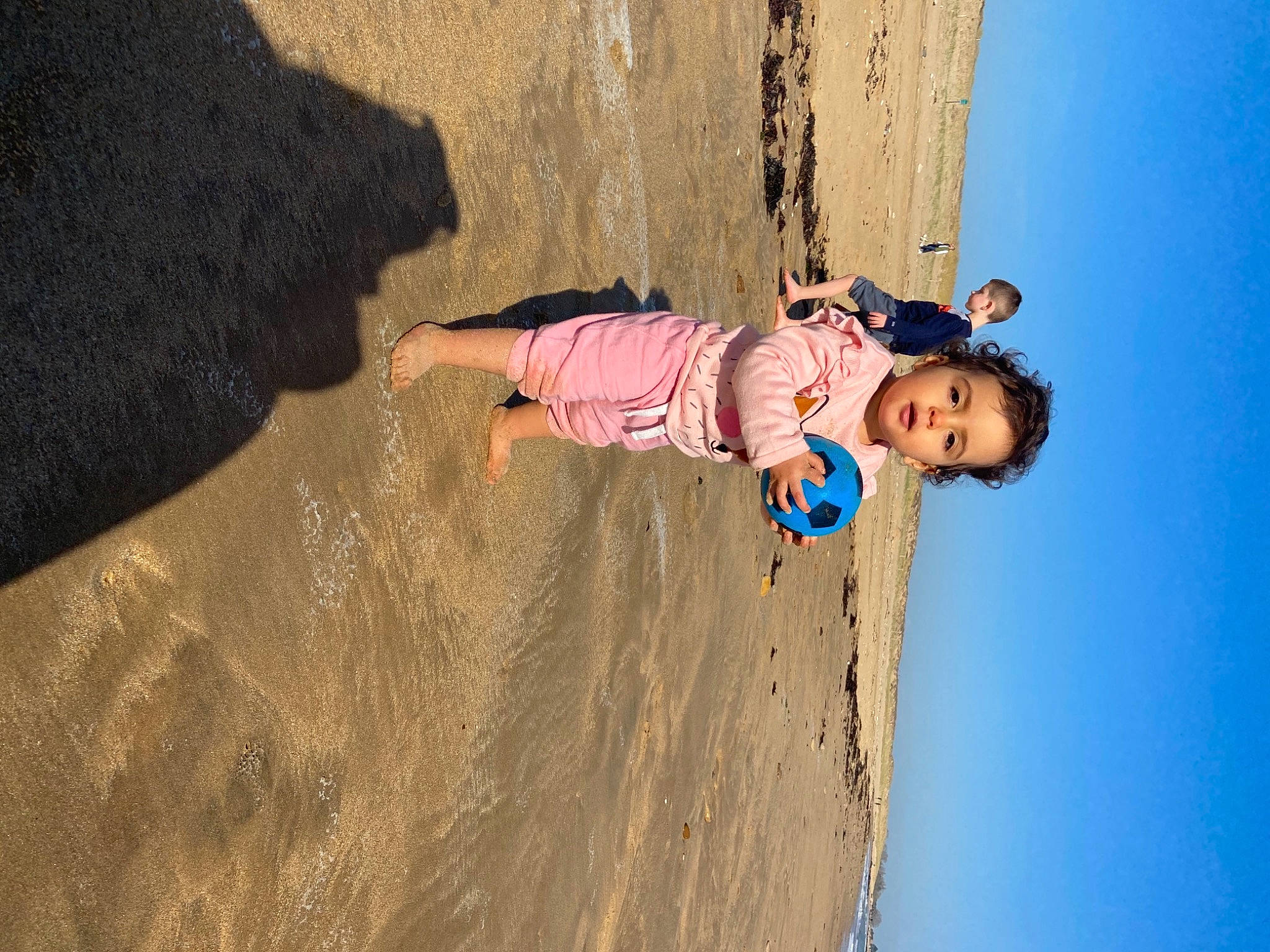 Cassie participe au concours pour gagner de l'argent avec cette photo : beach, body_of_water, child, electric_blue, fun, happy, landscape, leisure, mammal, people_in_nature, person, recreation, sand, shadow, sky, smile, soil, toddler, tree, water