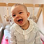 Ambre participe au concours pour gagner de l'argent avec cette photo : baby, child, smiling, happy, portrait, face, infant, clothing, white_shirt, ruffles, blue_eyes, sitting, indoor, crib, toy, soft_toy, pink_cushion, cute, person, closeup