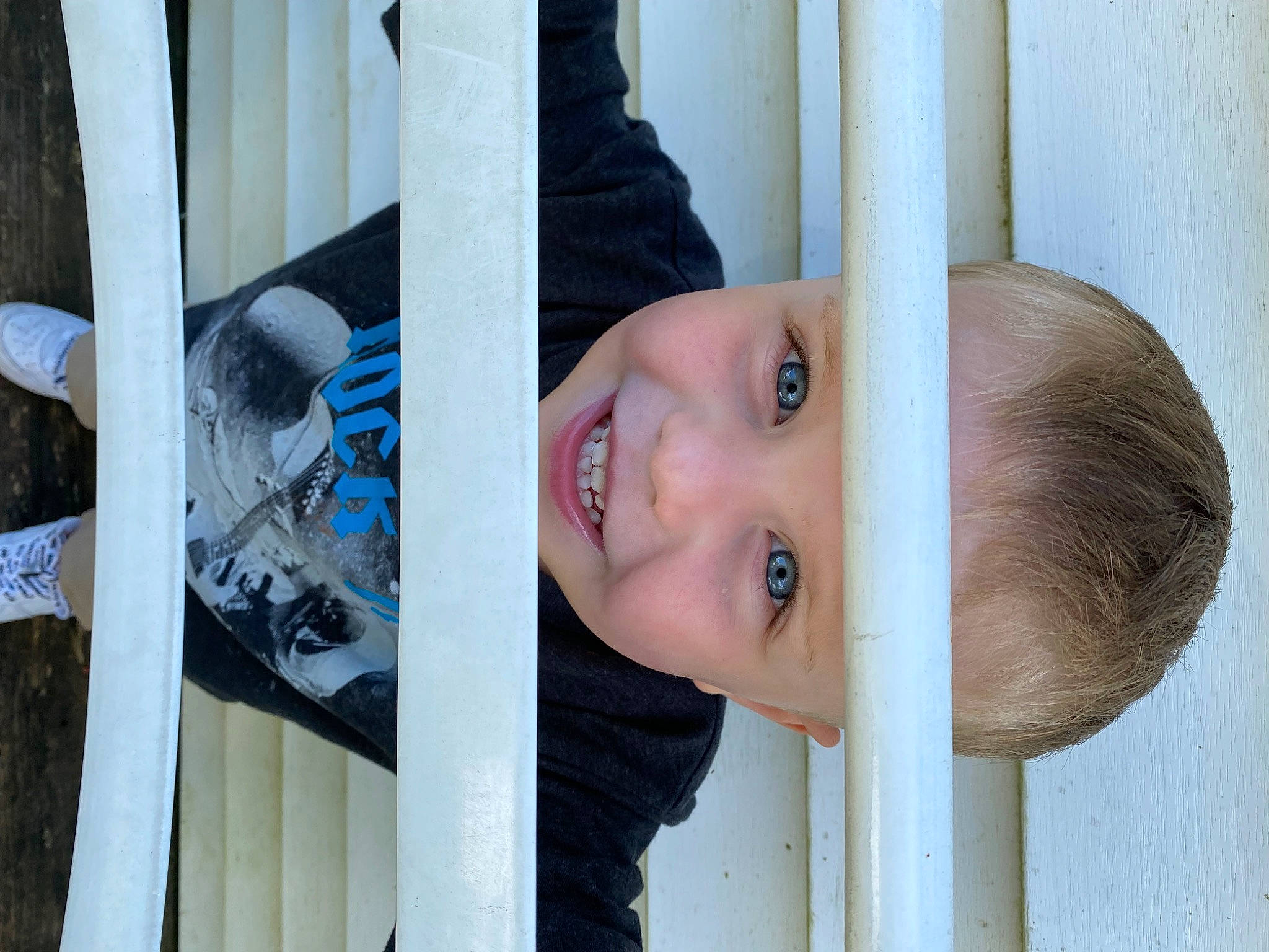 Justus is registered to the contest to win money with this photo: automotive_wheel_system, child, electric_blue, fun, happy, house, joy, leisure, person, portrait_photography, room, smile, standing, t_shirt, textile, toddler, vacation, window, wood