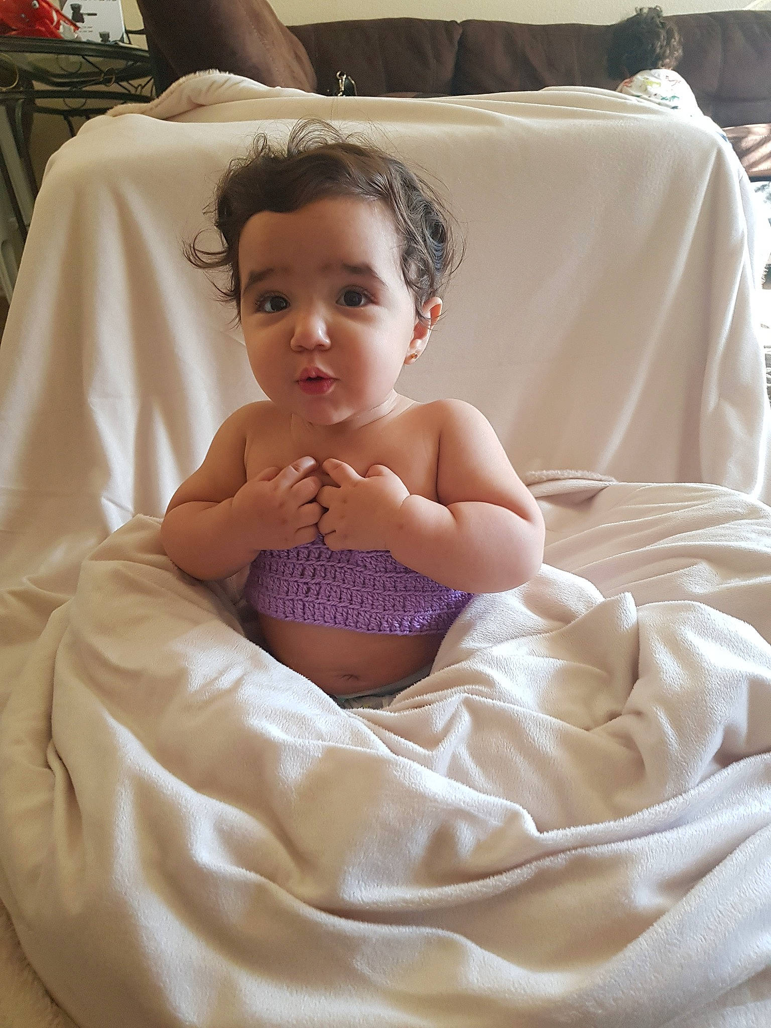 Tamara is registered to the contest to win money with this photo: baby, cheek, child, eye, face, finger, furniture, linens, person, sitting, skin, smile, textile, toddler