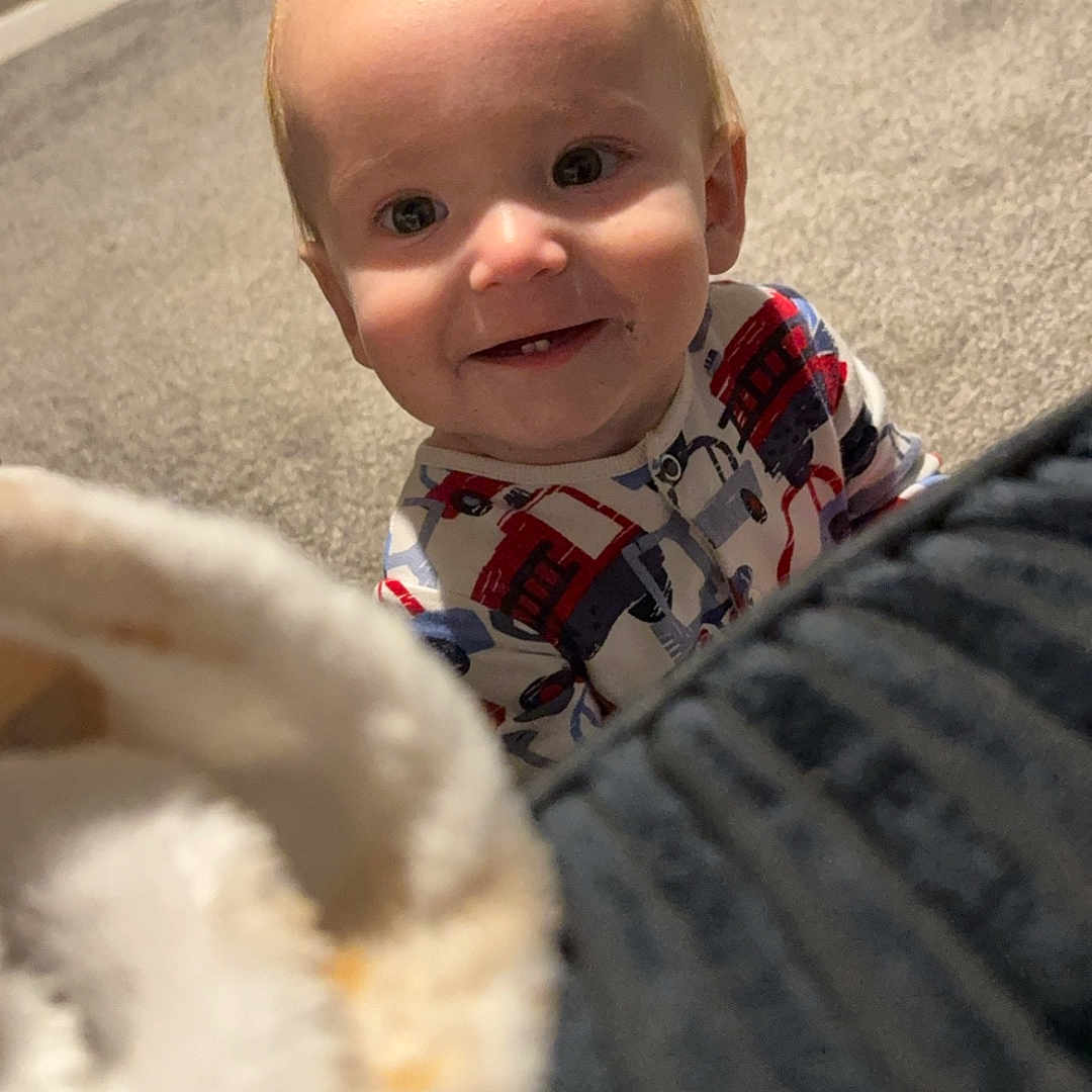 Huntley-Jaxson joined the competition — help win amazing prizes! baby, blanket, carpet, child, clothing, cozy, cute, face, floor, happy, head, home, indoor, infant, pajamas, person, playful, small, smile, young