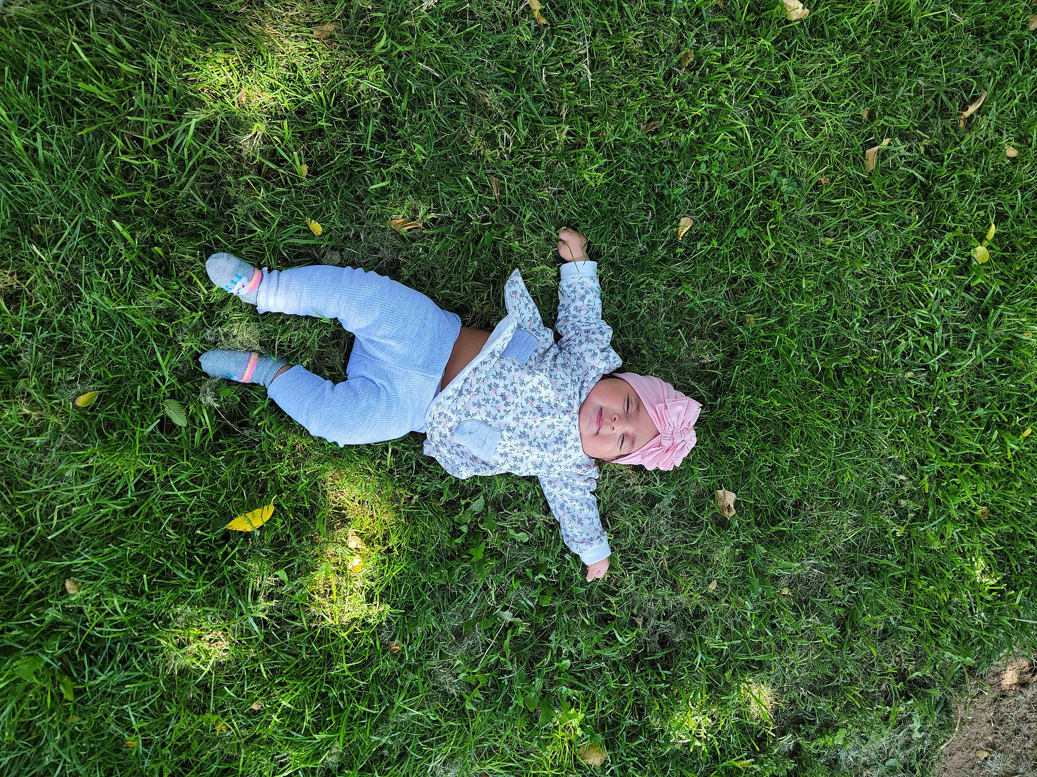 Azianna is registered to the contest to win money with this photo: flooring, fun, garden, grass, grassland, groundcover, happy, headwear, landscape, leisure, meadow, people_in_nature, person, plant, shadow, shrub, slope, vegetation