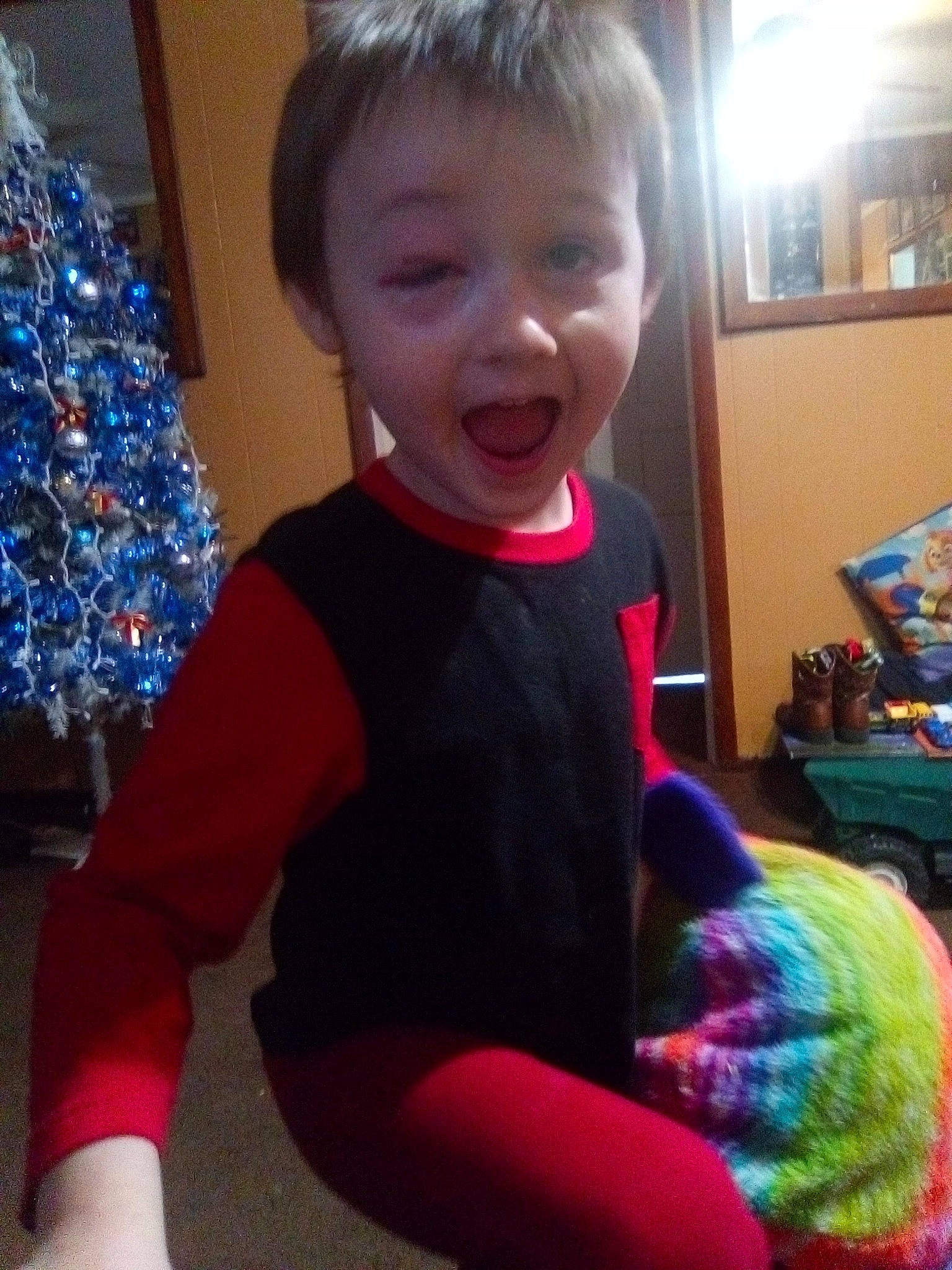 Kiya is registered to the contest to win money with this photo: baby, baby_toddler_clothing, blue, child, christmas_ornament, christmas_tree, cool, electric_blue, event, fun, happy, holiday_ornament, human_body, light, ornament, person, play, sleeve, smile, surprise