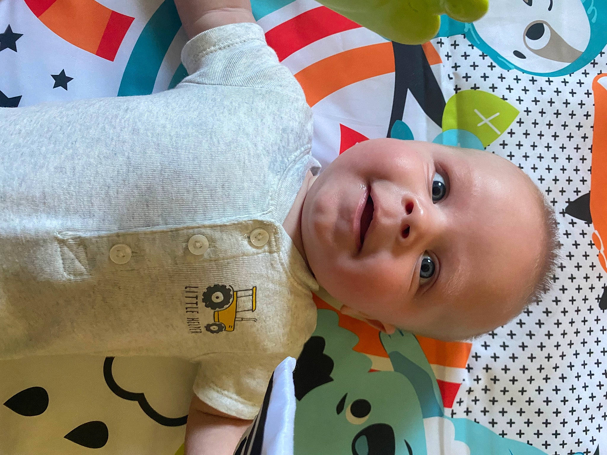 Zaxxton is registered to the contest to win money with this photo: baby, baby_products, baby_safety, baby_toddler_clothing, cheek, child, comfort, fun, gesture, green, happy, linens, nose, pattern, person, skin, sleeve, textile, toddler, white