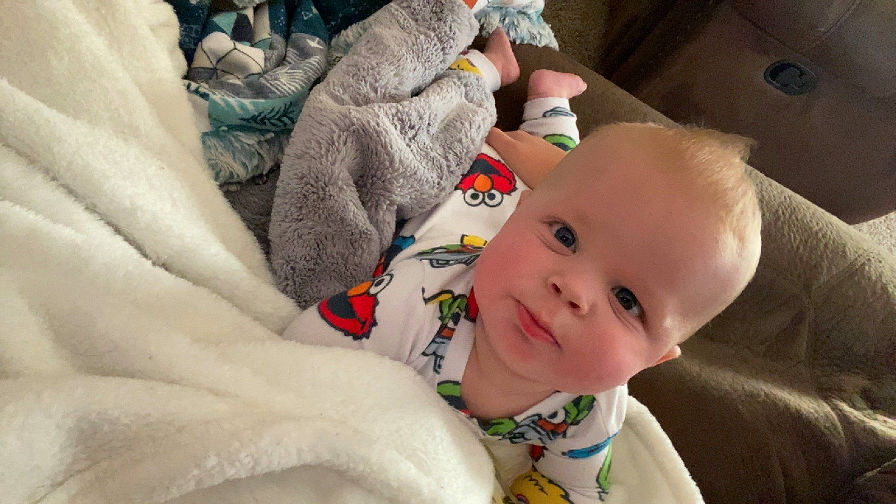 Zaxxton is registered to the contest to win money with this photo: baby, baby_products, baby_toddler_clothing, bedding, bedtime, carmine, cheek, child, comfort, happy, linens, person, room, sitting, textile, toddler