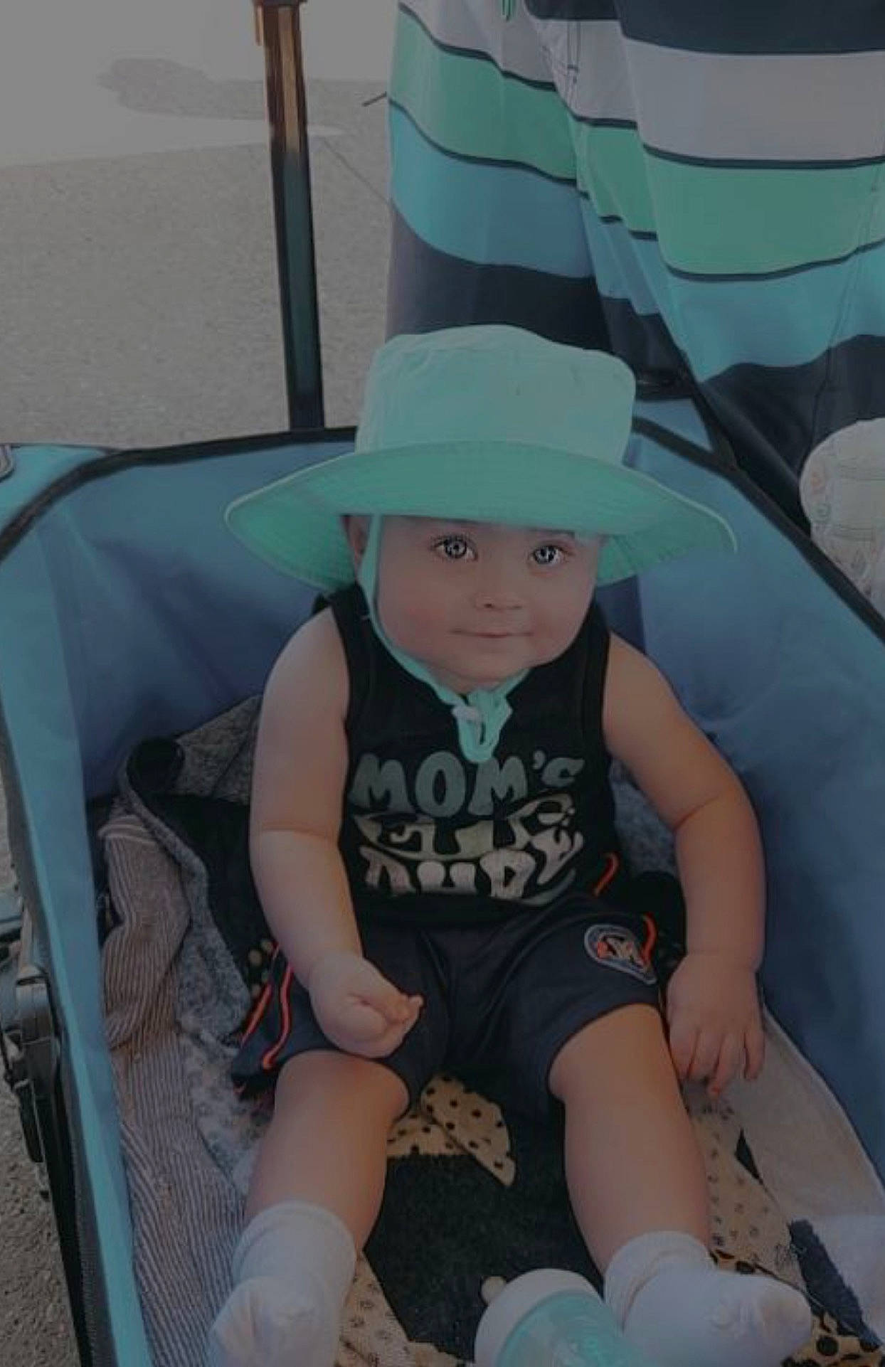 Roman is registered to the contest to win money with this photo: baby, baby_toddler_clothing, cap, chair, child, comfort, fun, hat, headwear, human_leg, knee, lap, leisure, pattern, person, personal_protective_equipment, shorts, sitting, t_shirt, thigh