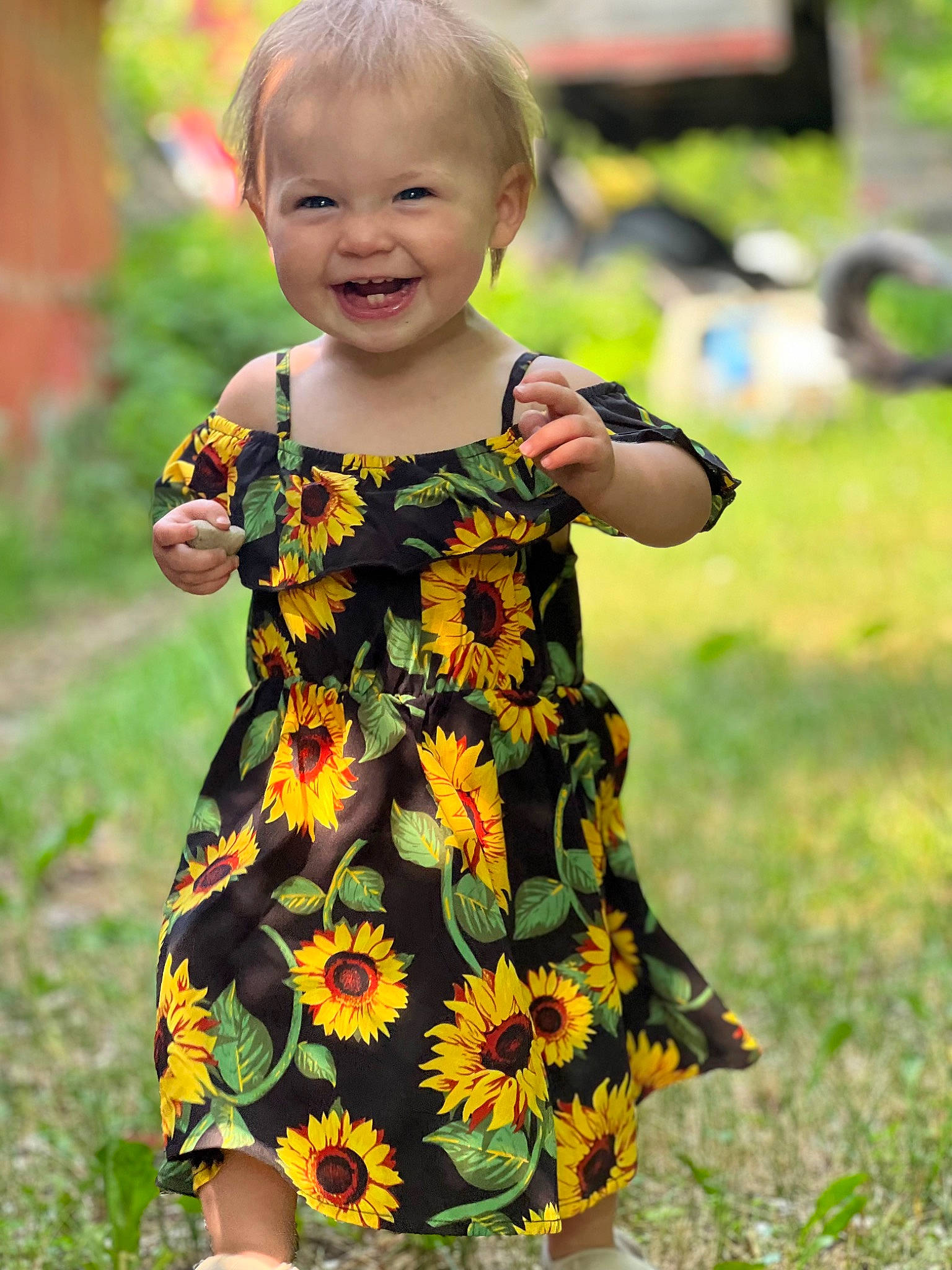 Aspen is registered to the contest to win money with this photo: baby, baby_toddler_clothing, child, day_dress, dress, face, grass, green, happy, head, joy, one_piece_garment, outerwear, pattern, people_in_nature, person, plant, sleeve, smile, t_shirt