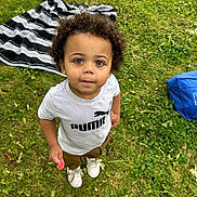 Micah is registered to the contest to win money with this photo: child, clothing, face, female, footwear, girl, grass, head, lawn, nature, outdoors, park, person, photography, plant, portrait, shoe, shorts, t_shirt, yard