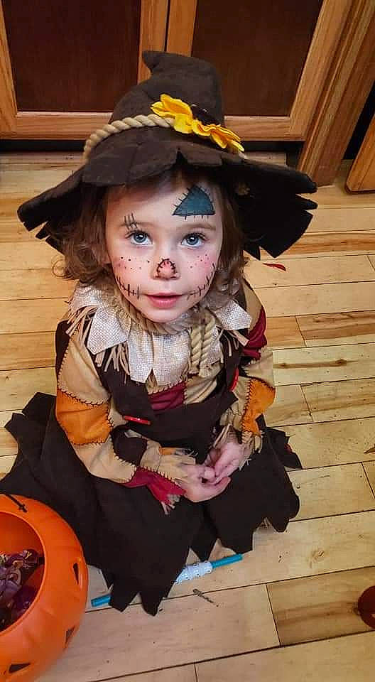 Geneva is registered to the contest to win money with this photo: child, child_model, costume, fashion_accessory, hat, headgear, person, pumpkin, toddler, trick_or_treat, witch_hat