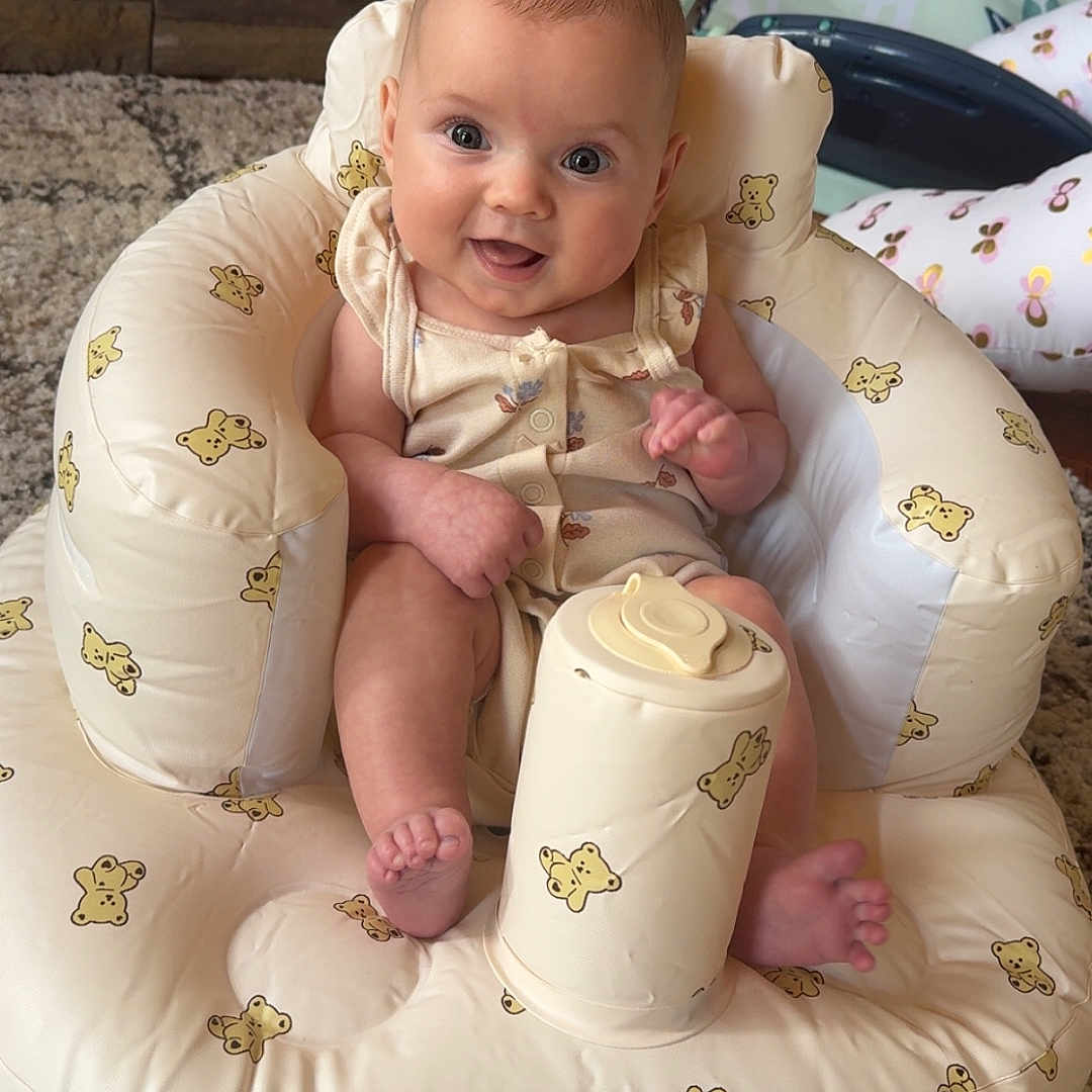 Emery joined the competition — help win amazing prizes! baby, infant, smiling, child, cushion, teddy_bear_print, baby_chair, carpet, toy, indoor, cute, happy, person, face, foot, hand, clothing, home, comfort, sitting