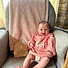 Emery joined the competition — help win amazing prizes! baby, infant, smiling, pink_sweater, armchair, blanket, milestone_sign, wooden_sign, 4_months, happy, cute, indoors, cozy, portrait, child, person, face, hands, feet, home