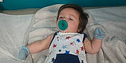 Ryder is registered to the contest to win money with this photo: baby, bed, blanket, calm, child, comfort, cute, indoor, infant, lying_down, mittens, nursery, pacifier, person, resting, romper, sleepwear, soft_fabric, star_pattern, young_child