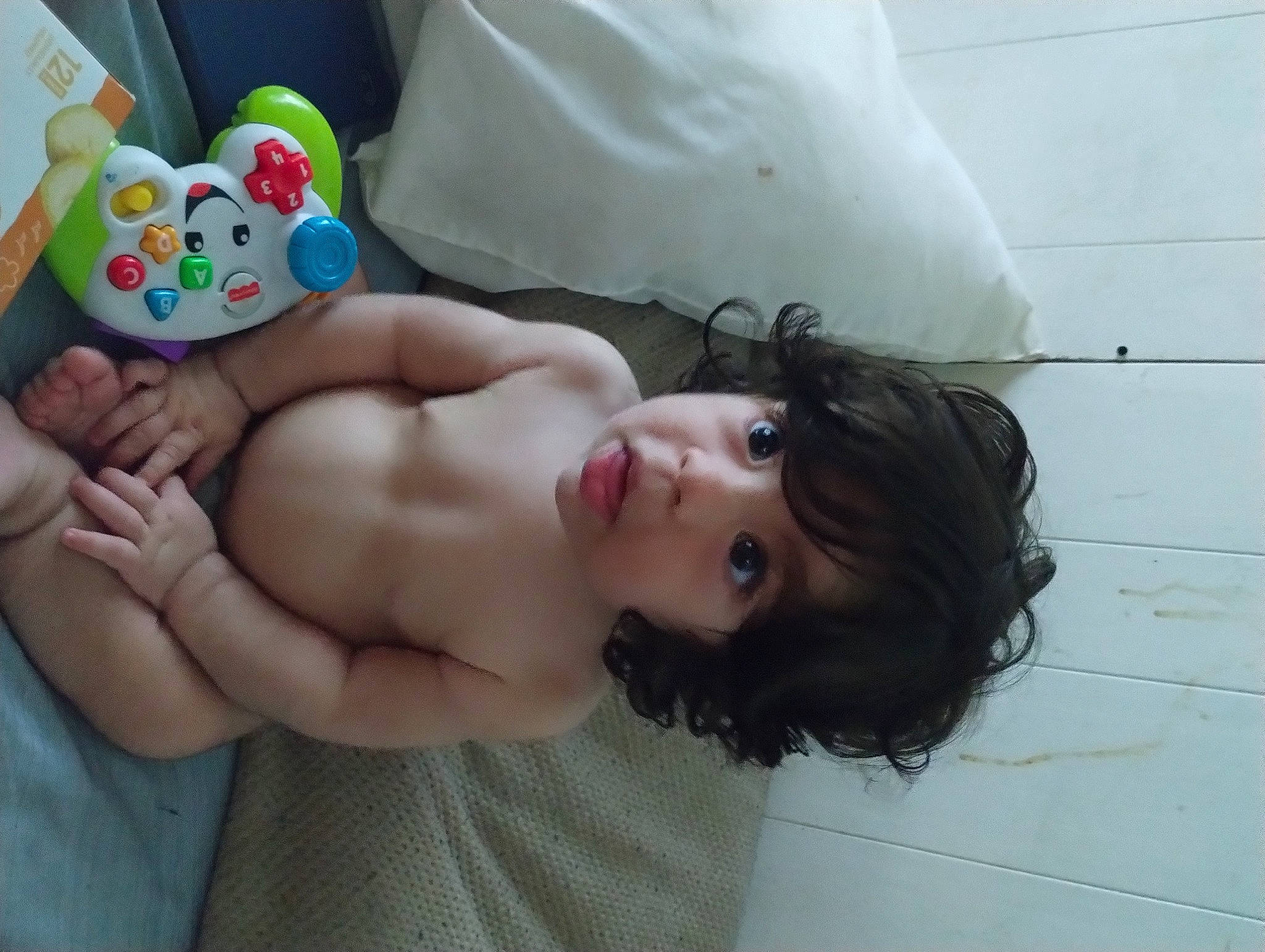 Kylie is registered to the contest to win money with this photo: abdomen, baby, chest, child, comfort, finger, fun, gadget, hand, happy, human_body, human_leg, joint, mouth, person, skin, stuffed_toy, thigh, toddler, toy