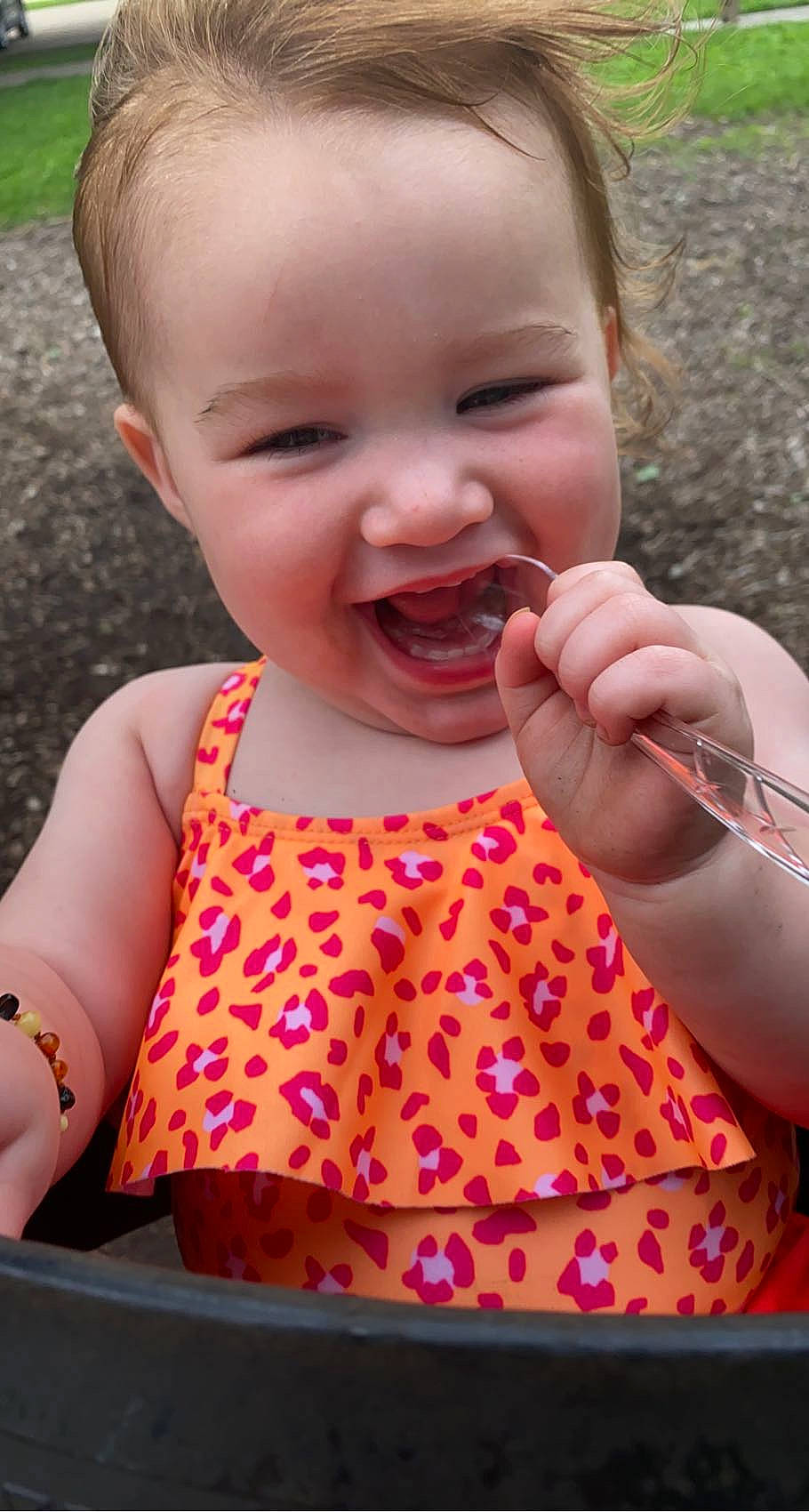 Paislee is registered to the contest to win money with this photo: arm, baby_toddler_clothing, cheek, dress, facial_expression, finger, gesture, hand, happy, iris, lip, mouth, nose, organ, person, pink, product, skin, sleeve, smile