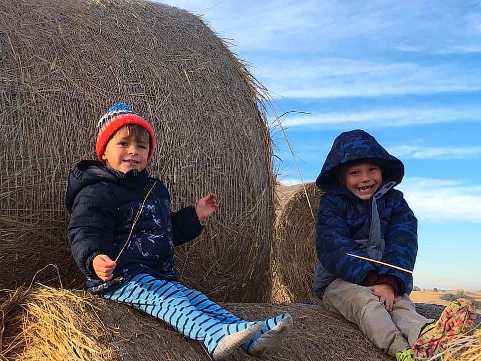 Jackson is registered to the contest to win money with this photo: adaptation, blue, child, cloud, fun, grass, grass_family, grassland, happy, hat, headwear, jacket, joy, landscape, leisure, outerwear, people_in_nature, person, sky, toddler