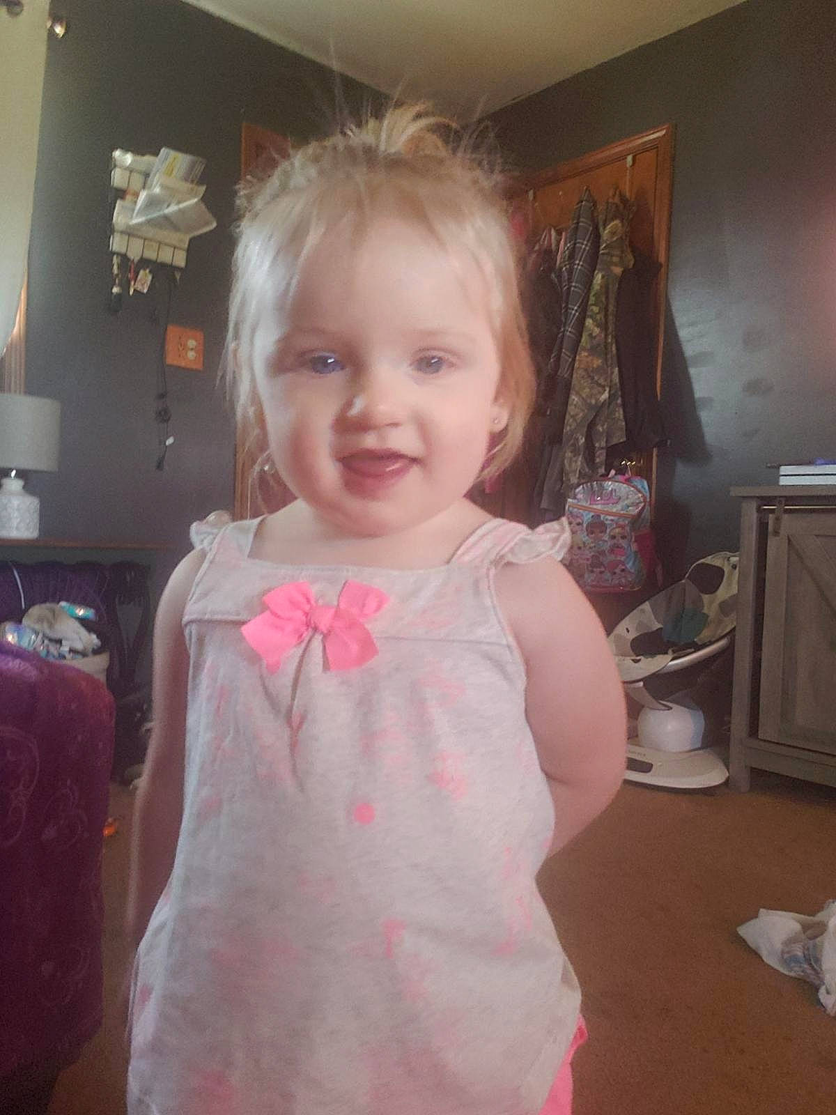 Lyberty is registered to the contest to win money with this photo: cheek, child, dress, face, hair, head, iris, long_hair, person, pink, room, shoulder, skin, smile, standing, toddler