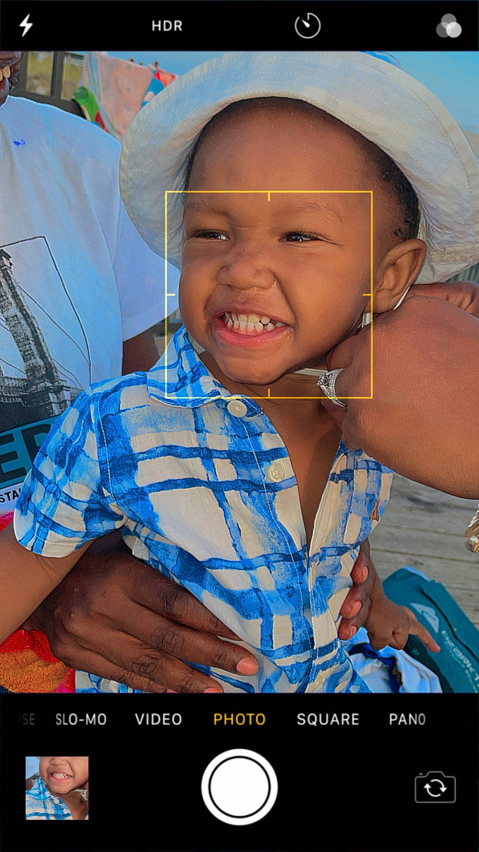 Aaron is registered to the contest to win money with this photo: adaptation, cap, child, communication_device, electric_blue, facial_expression, flash_photography, fun, gadget, happy, human, mobile_device, mobile_phone, muscle, organ, person, photograph, portable_communications_device, skin, smile