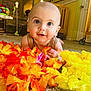 Bentley joined the competition — help win amazing prizes! baby, infant, child, carpet, flowers, orange_flowers, yellow_flowers, indoors, home, furniture, crib, face, eyes, smile, cute, toddler, floor, colorful, playful, portrait