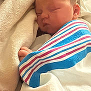 Oaklynn is registered to the contest to win money with this photo: baby, newborn, sleeping, swaddled, striped_blanket, hospital_blanket, blanket, pillow, cheek, face, hand, infant, portrait, cozy, cute, resting, soft, fabric, bed, nursery