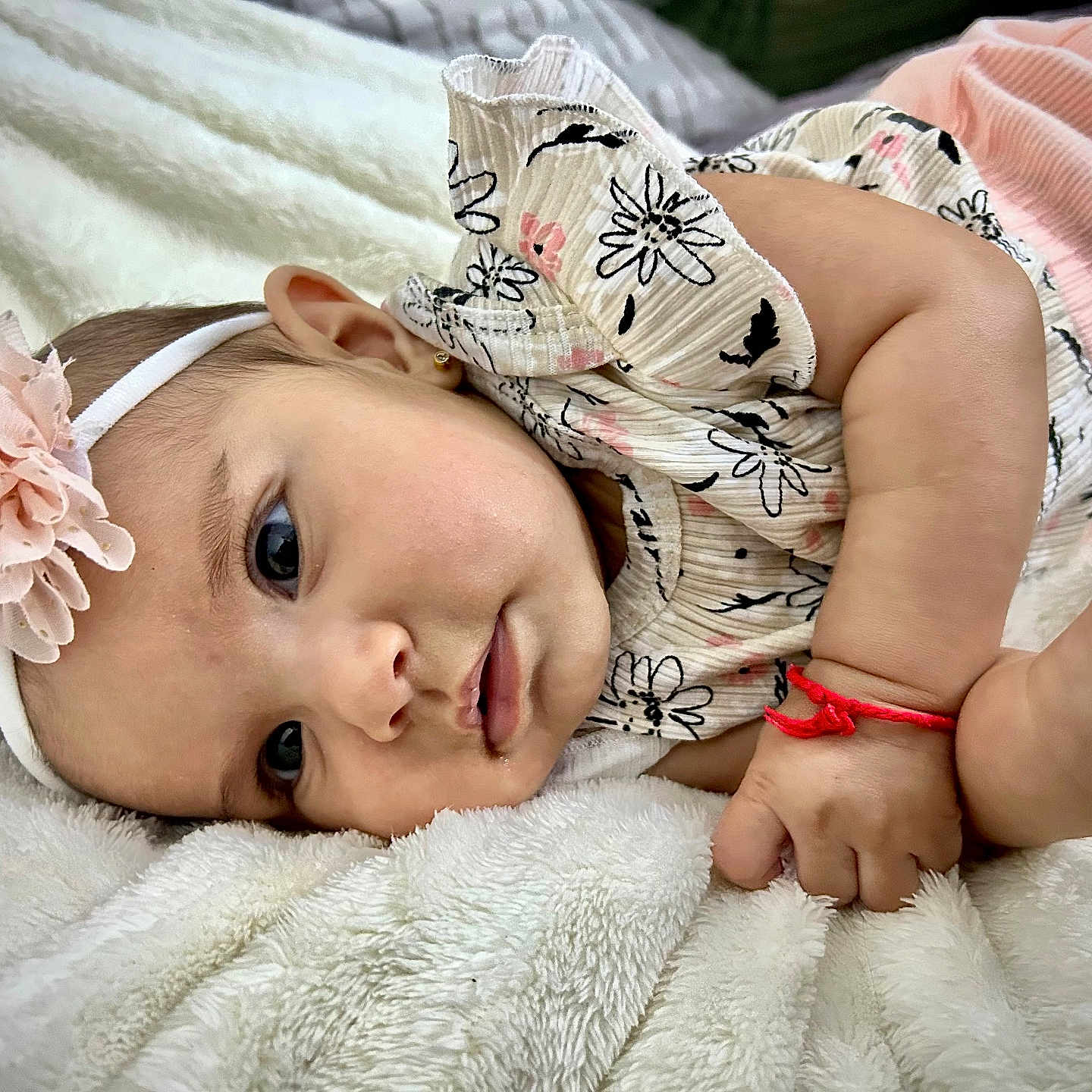 Monserrat is registered to the contest to win money with this photo: adorable, baby, blanket, child, closeup, clothing, cute, face, flower, hand, headband, infant, lying_down, newborn, pink, portrait, resting, skin, soft, white