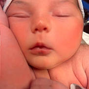 Mia is registered to the contest to win money with this photo: newborn, baby, sleeping, close_up, infant, soft_hat, peaceful, resting, hand, arm, skin, cute, portrait, young, child, tender, calm, indoors, human, face