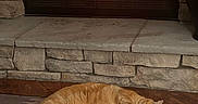 Garfield is registered to the contest to win money with this photo: animal, cat, comfort, cozy, domestic, fire, fireplace, fur, hearth, home, indoor, orange_tabby, pet, relaxing, resting, rug, sleeping, stone_wall, warm, wood_floor